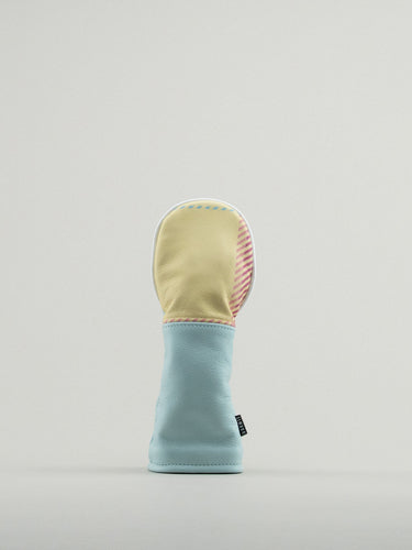 Golf club headcover made of pink and yellow plaid with a blue leather base.