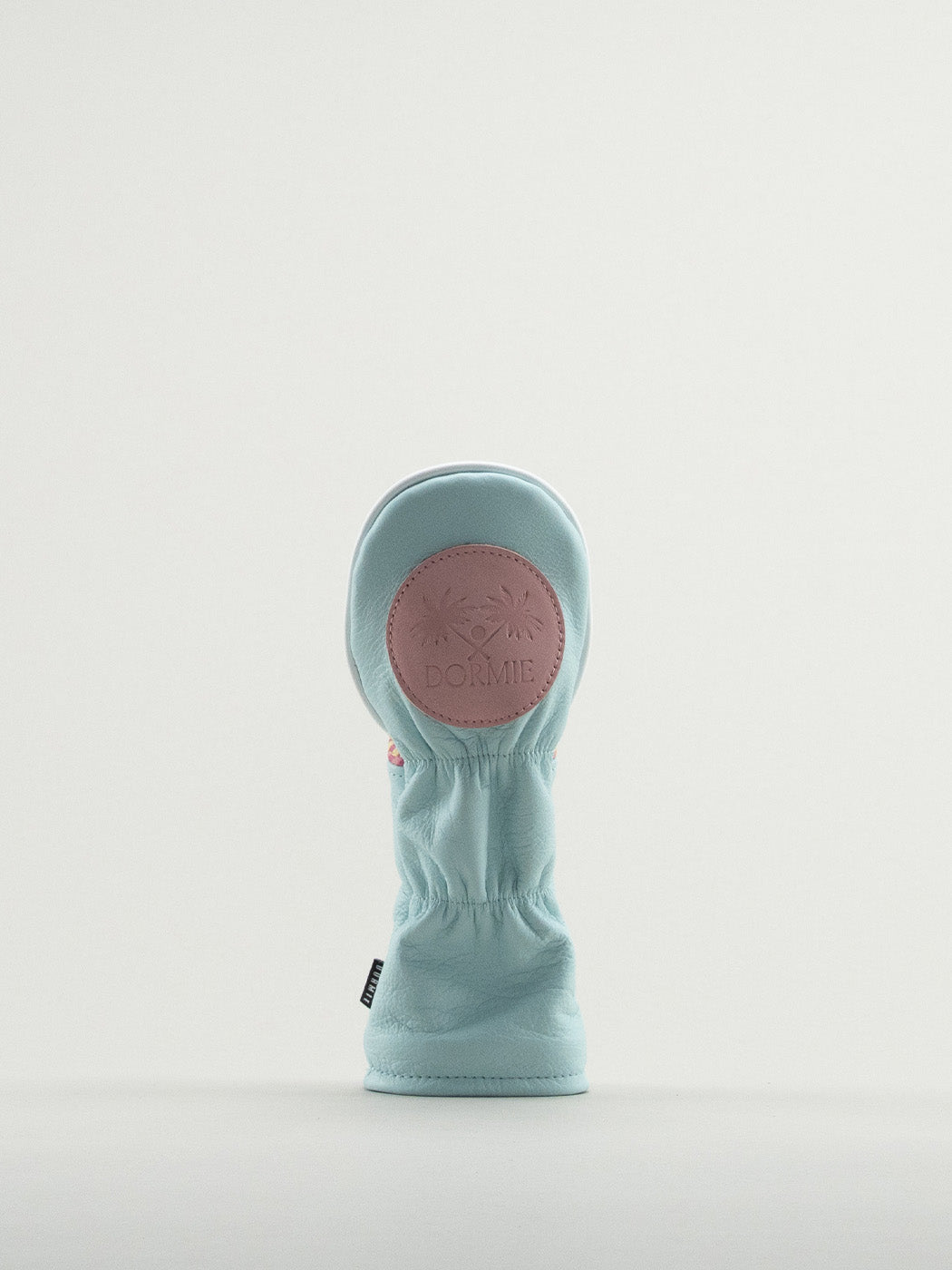 Reverse of blue leather headcover showing pink Dormie badge